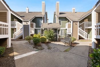 A sunny day at a residential complex with a small garden in the middle.